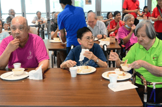 A group of people eating at a table
AI-generated content may be incorrect.