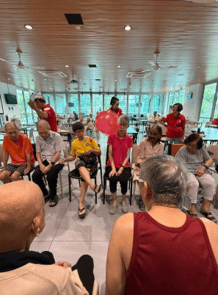 A group of people sitting in chairs in a room
AI-generated content may be incorrect.