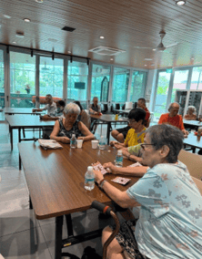 A group of people sitting at a table
AI-generated content may be incorrect.