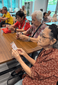 A group of people sitting at a table playing cards
AI-generated content may be incorrect.
